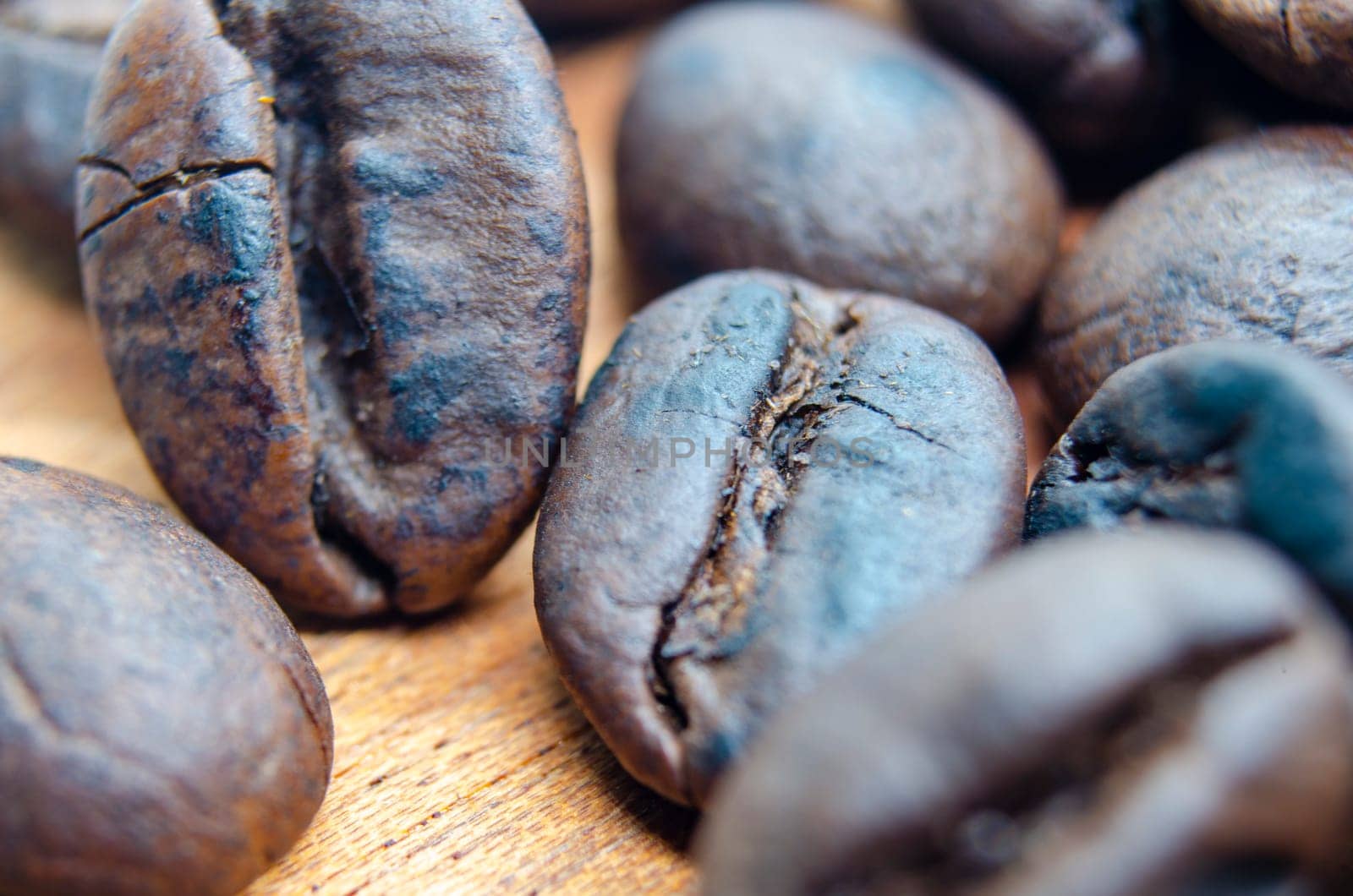 Micro photography of roasted coffee beans with customizable space for text. Coffee beans concept.