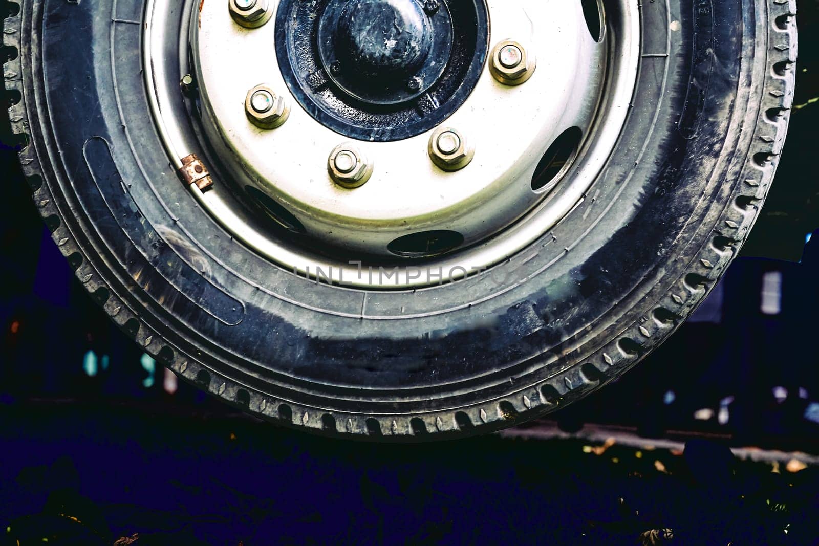 a circular object that revolves on an axle and is fixed below a vehicle
