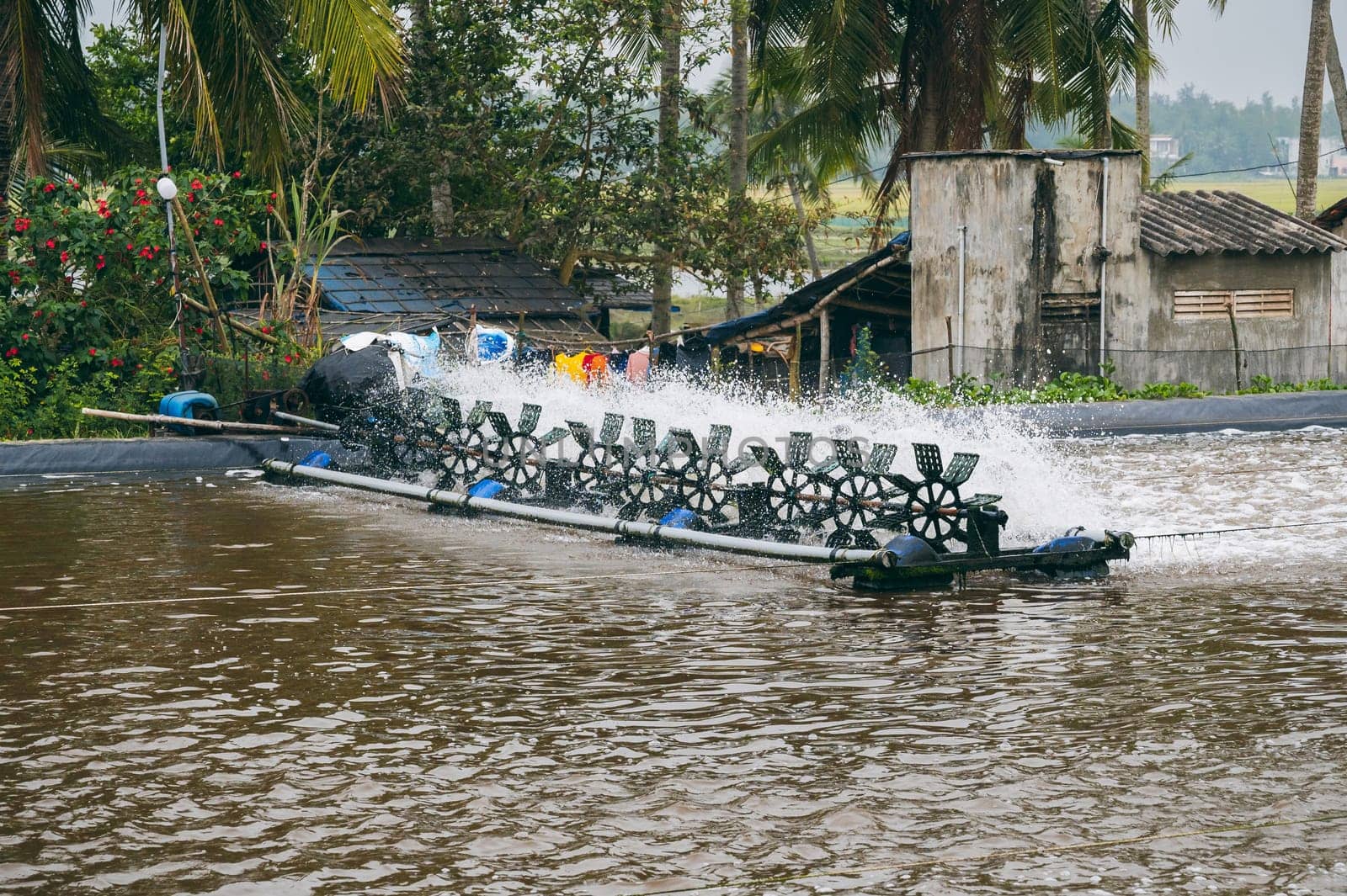 Aerator blades in pond on fish farm. Breeding fish and shrimps in an artificial pond