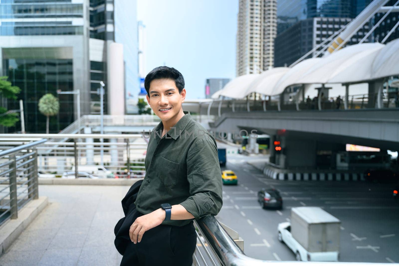 Confident businessman taking a break in a bustling commercial district.