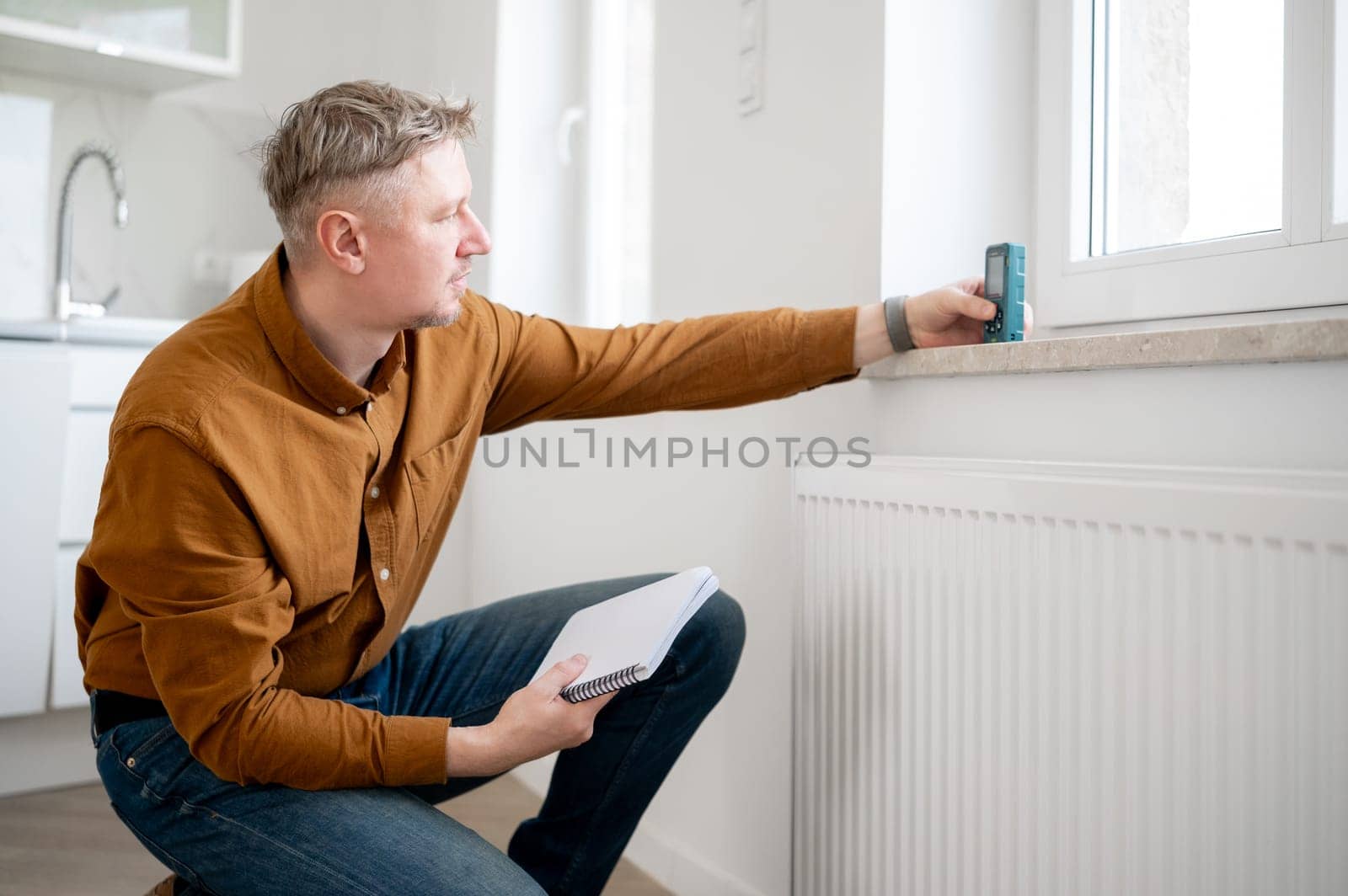 Man Measuring Window Height With A Special Device