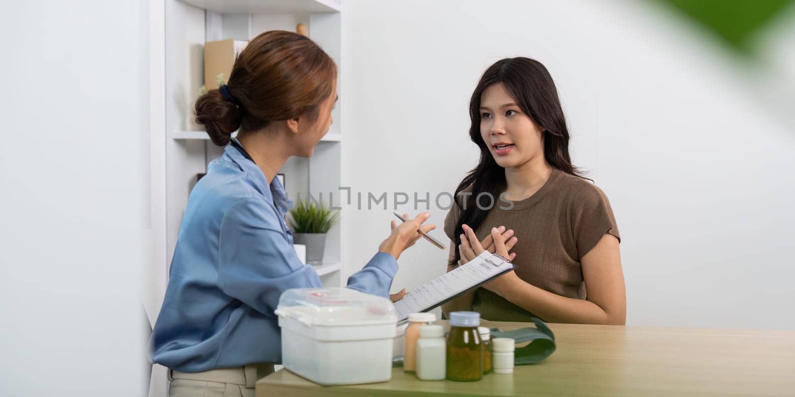 A female patient engages in a detailed discussion about her health with a doctor, highlighting the importance of communication in healthcare.