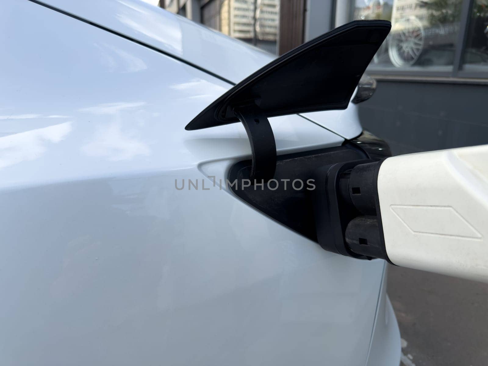 Electric car being charged, reflecting the shift from traditional fuel refueling to modern plug in energy solutions in today sustainable transportation reality
