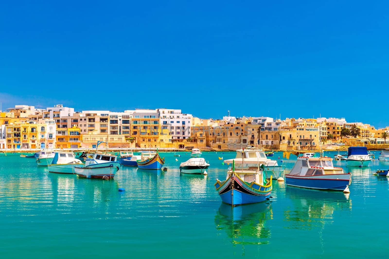 A view of numerous fishing boats in St George's Bay in Birzebbuga, a small coastal town in Malta.