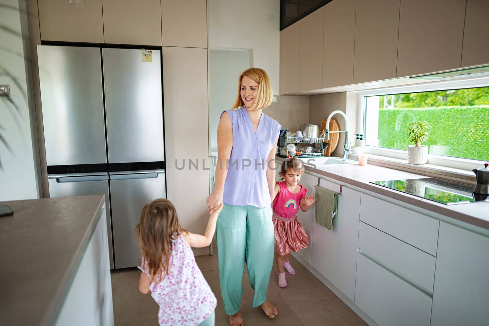 Lively morning in a stylish kitchen with children playing.