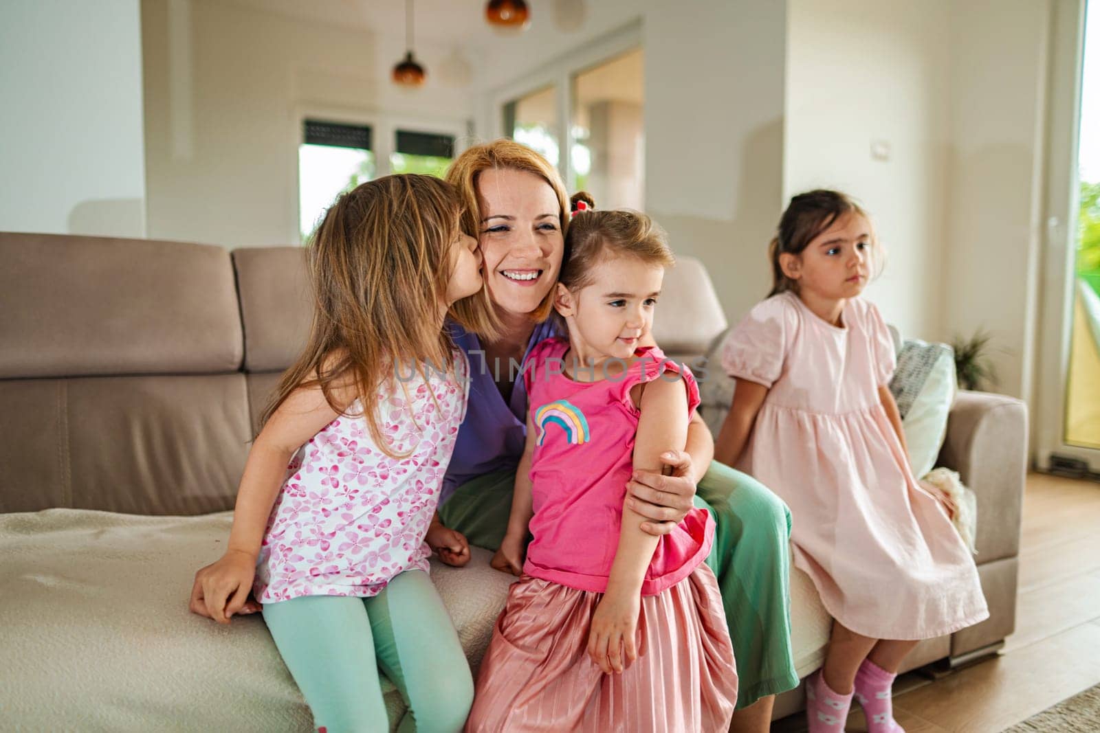 Happy children share a loving embrace with their mother.