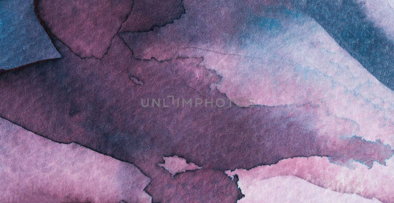 Vibrant watercolor artwork displays a blend of purple and blue tones on textured paper. The flowing colors create an abstract composition that inspires creativity and calmness.