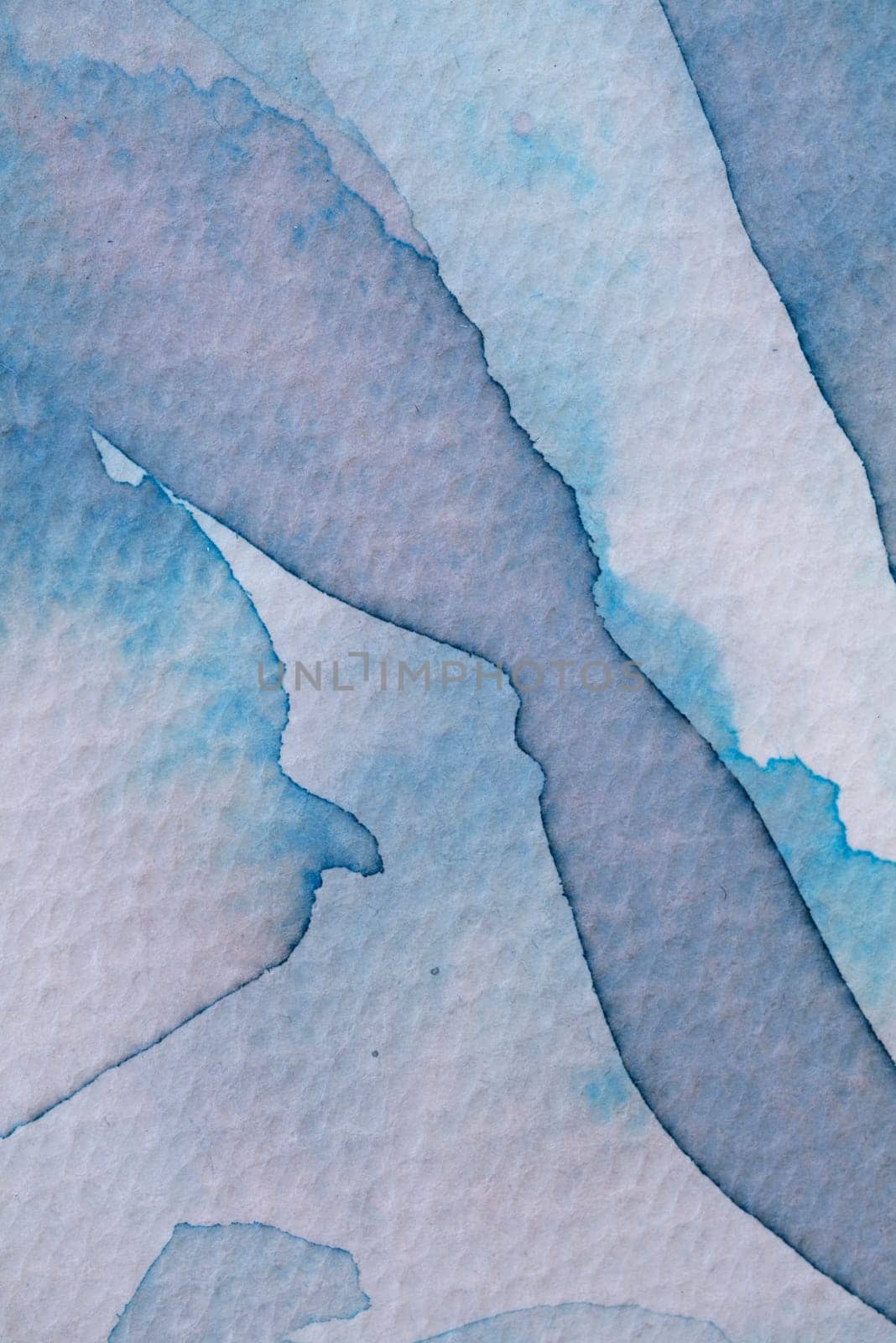 Soft blue and gray watercolor shapes blend together in an abstract composition, creating a serene and calming effect. The gentle transitions between colors form a harmonious interplay of hues.