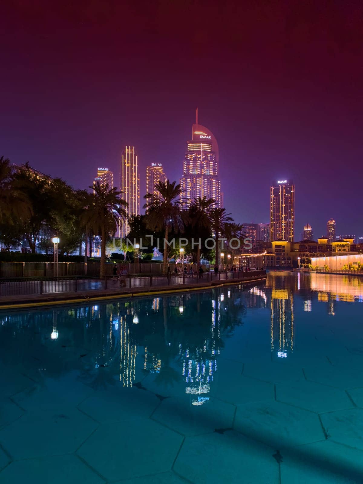 UAE, Dubai, 26 September 2024: The famous shopping center Dubai Mall and Burj Khalifa skyscraper at dusk, Dubai's sights and skyscrapers illuminated at night, palm trees. High quality photo