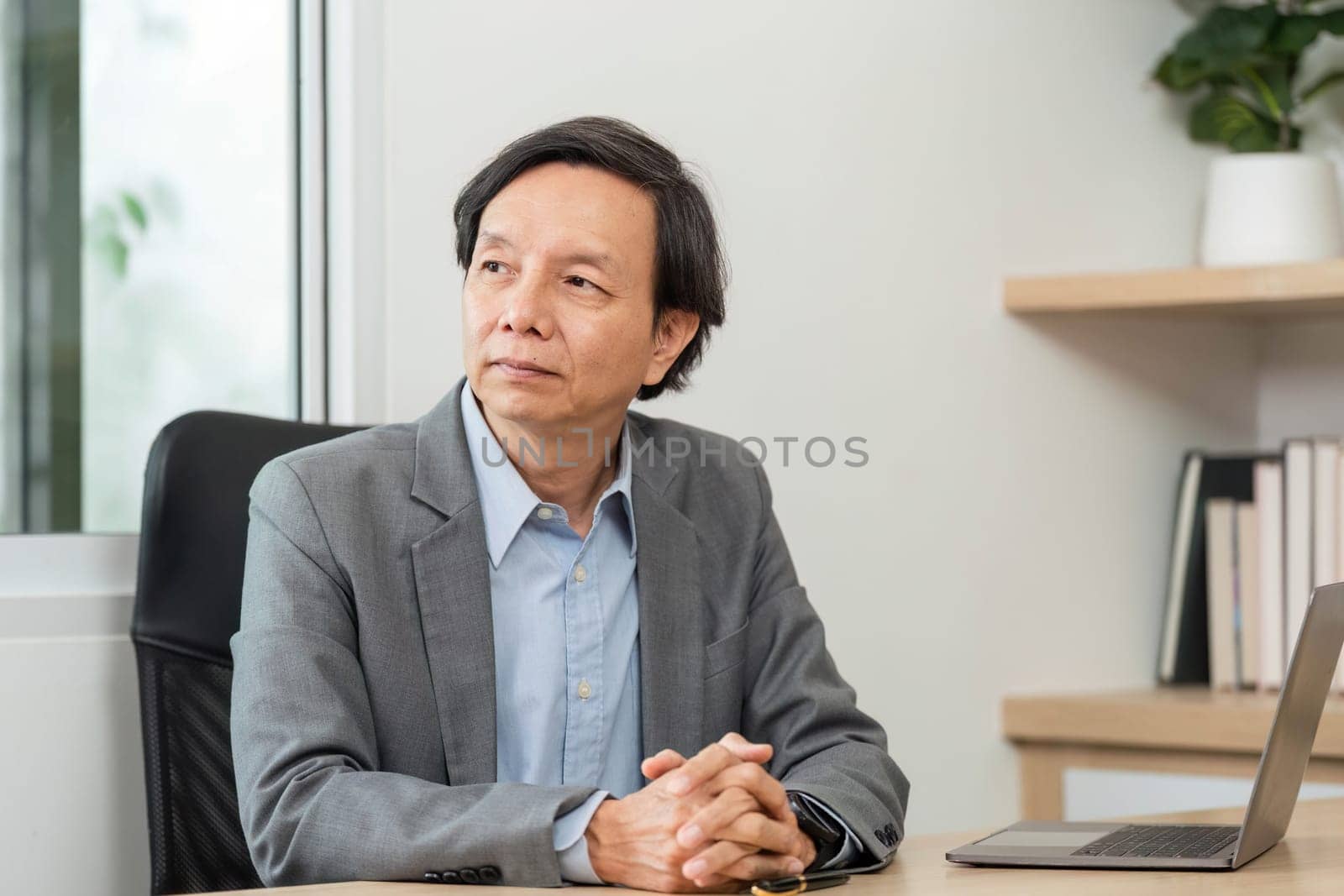 A businessman attentively engages in a meeting, analyzing financial data and charts in a contemporary workspace.