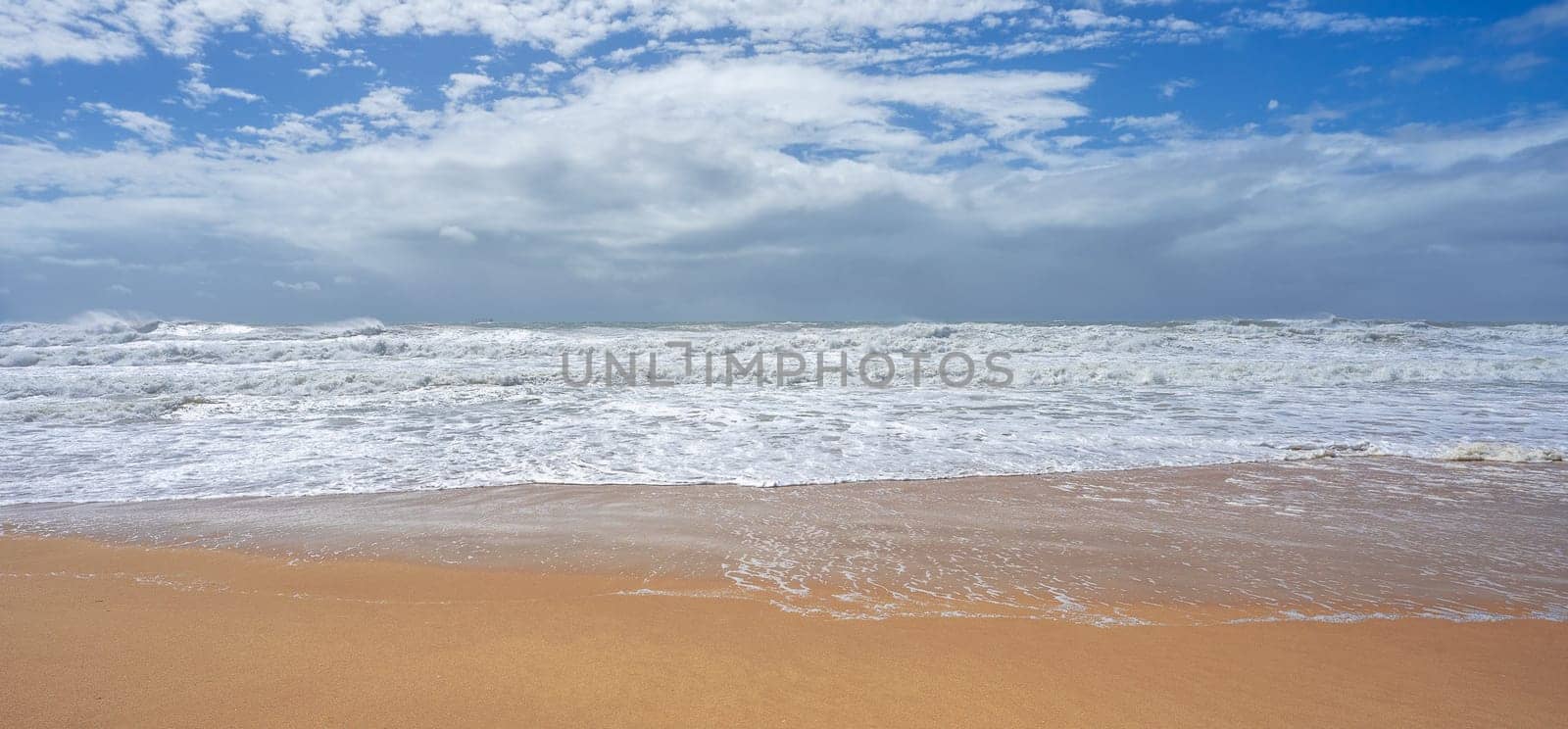 Very rough seas whipped up by the winds of an approaching cyclone with rain on the horizon