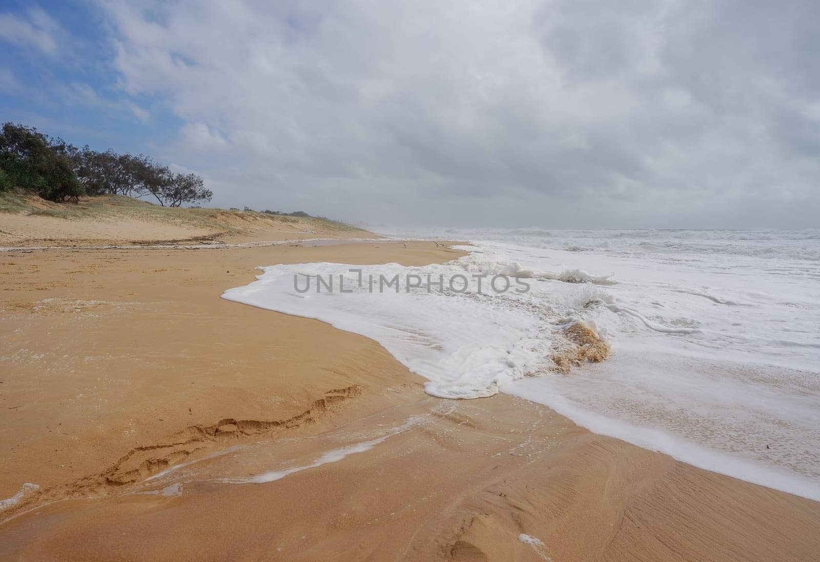 Foamy surf waves rolling in during Rough Weather from Tropical Cyclone Alfred at Buddina Beach on Sushine Coast Maroochydore Queensland