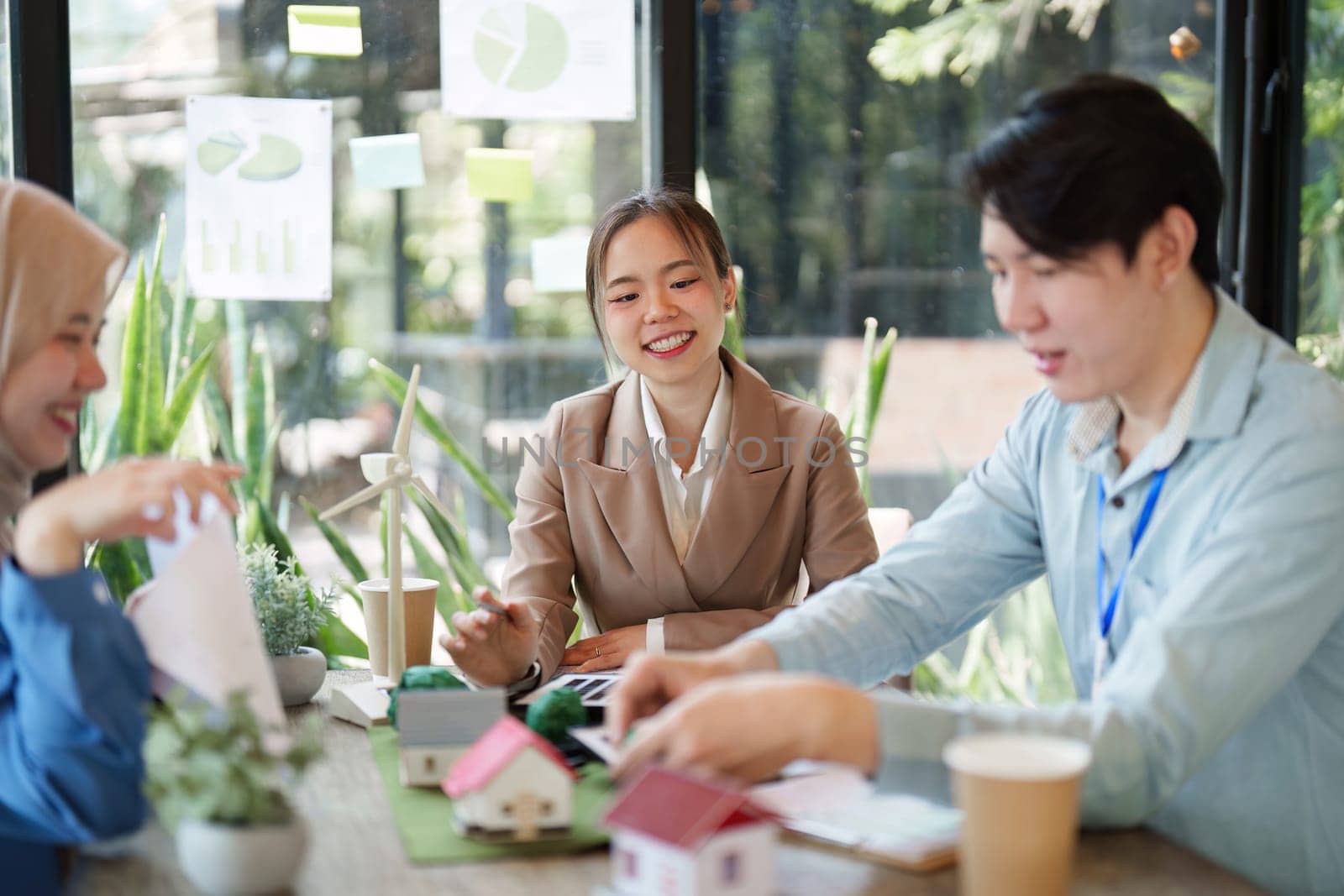 A group of professionals engaged in a collaborative discussion about sustainable architecture and environmental design, showcasing innovative ideas in a natural setting.