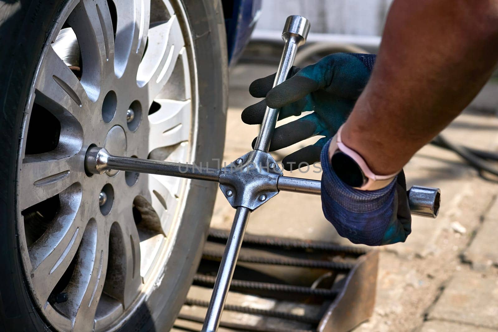 Replacing a car wheel at a tire station. a rubber covering, typically inflated or surrounding an inflated inner tube