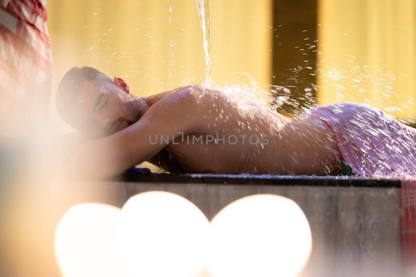 Water Treatment in Turkish Hammam.Man receiving water therapy inside a traditional Turkish hammam with ornate details.