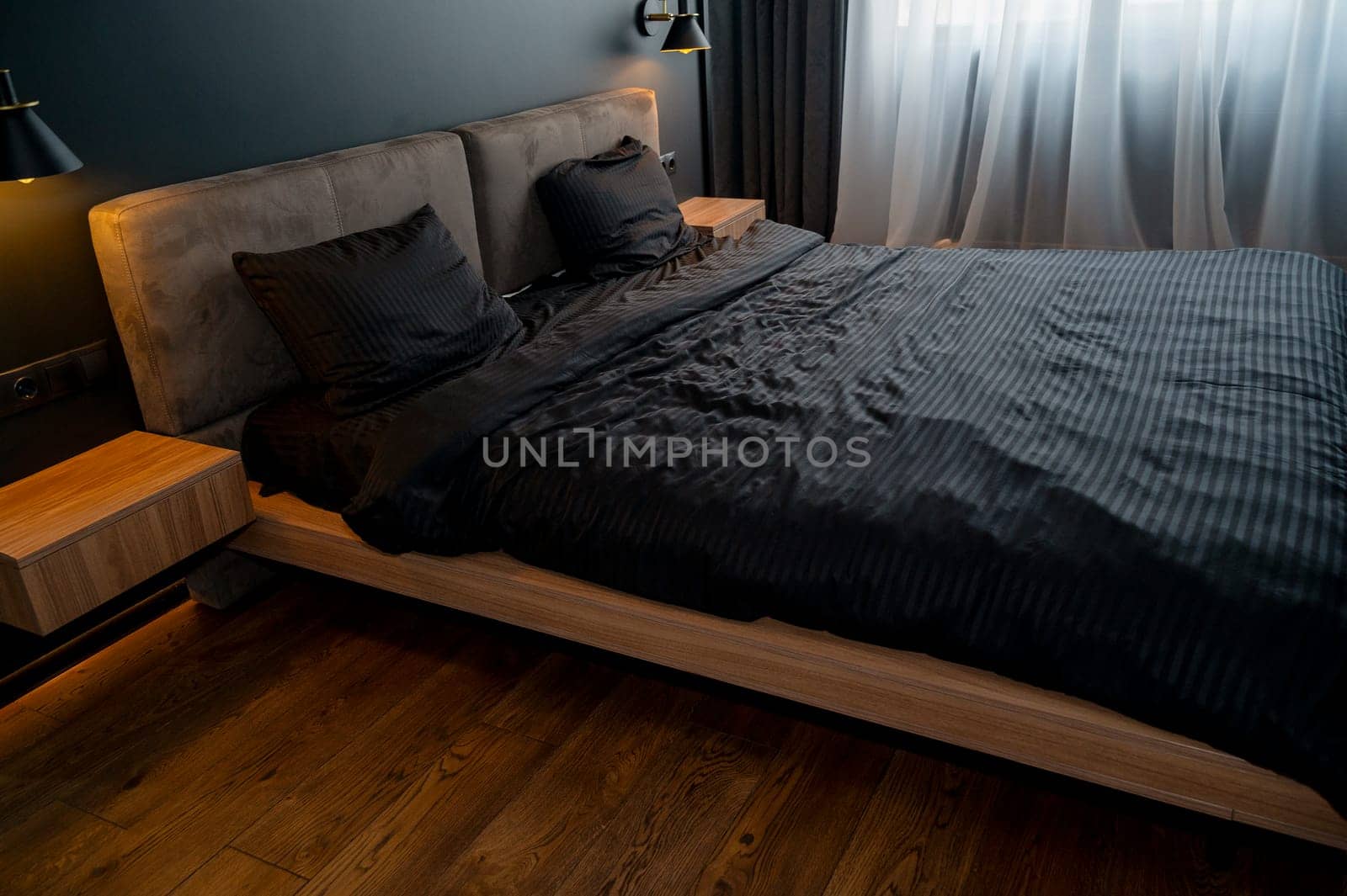 A large bed sitting in a room. High quality photo