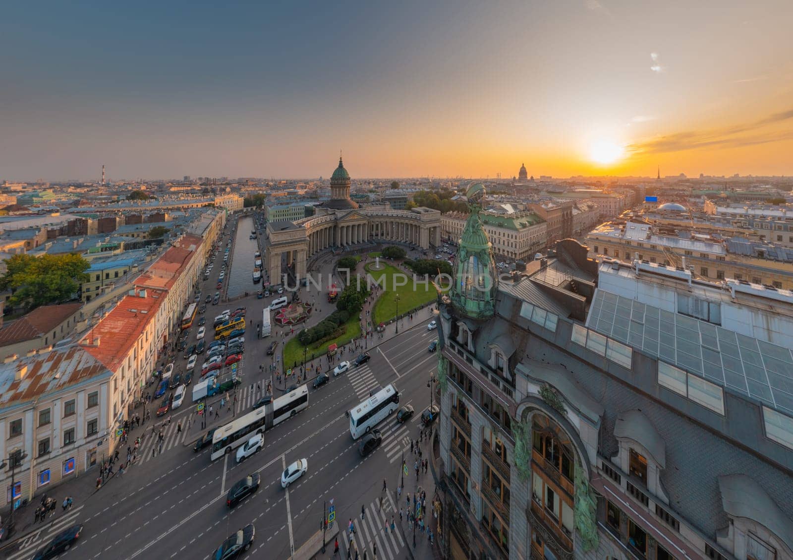 Drone view of Zinger House and Book House, fountain in front of Kazan Cathedral and Isaac cathedral at sunset, Griboyedov Canal, busy traffic along Nevsky avenue, rooftops, Russia, St.Petersburg. High quality photo