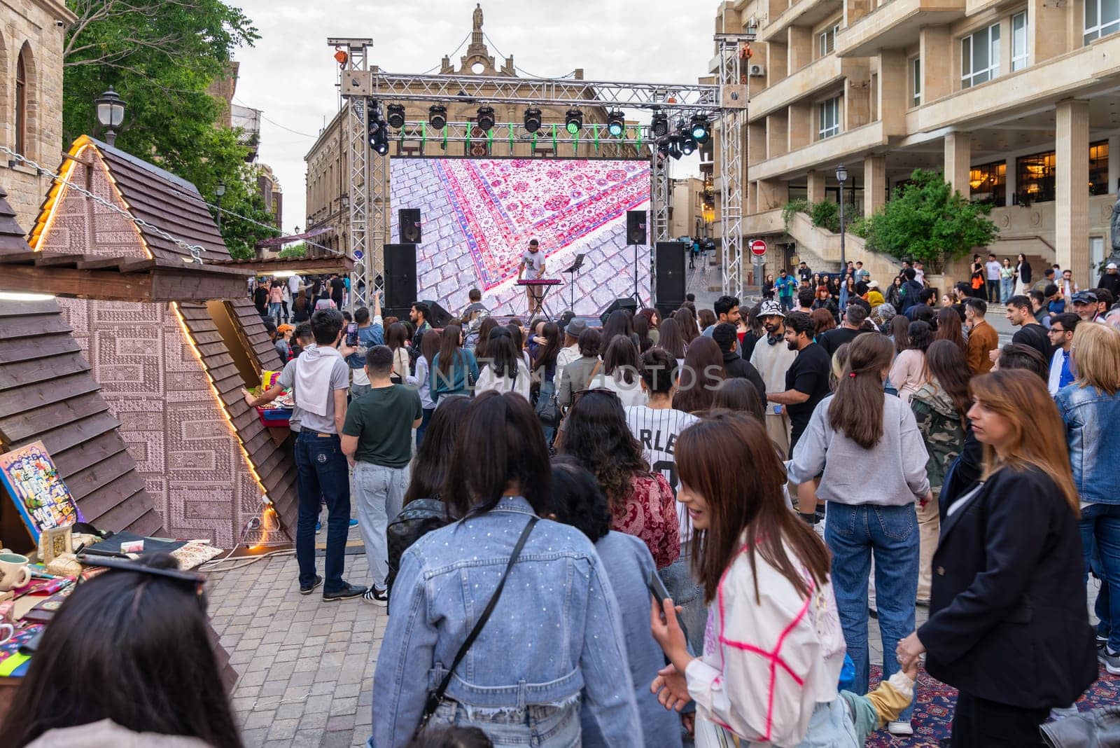 Baku, Azerbaijan - May 4 2024: Substantial crowd gather for a concert at the First National Carpet Festival of Azerbaijan. The event was held in the Old Town, or Icherisheher, the historic walled city