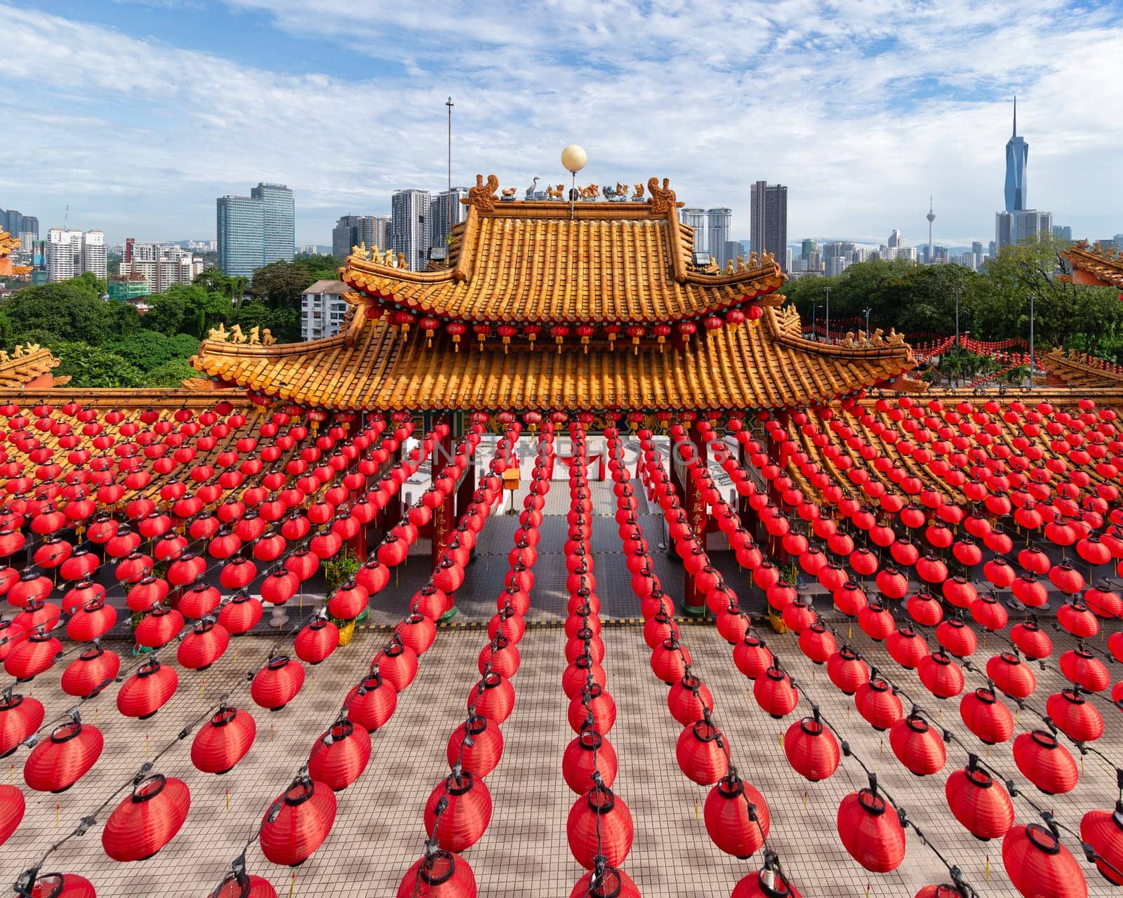 Stunning architecture of Thean Hou Temple in Kuala Lumpur, Malaysia, adorned with bright red lanterns and surrounded by a modern city skyline