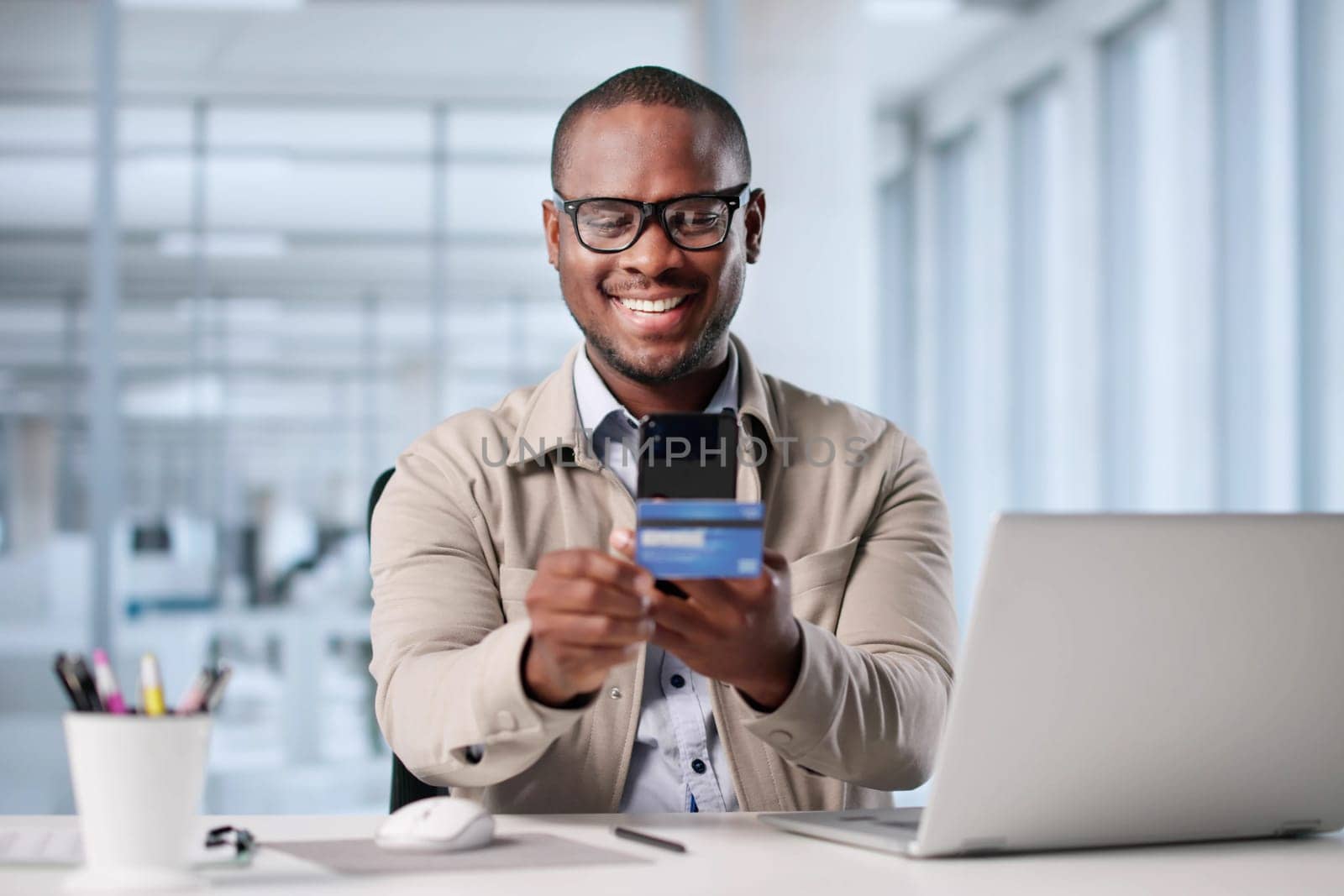 Man Using Mobile Phone To Take Photo Of Credit Card. Possible Professions: Online Shopper, Photographer