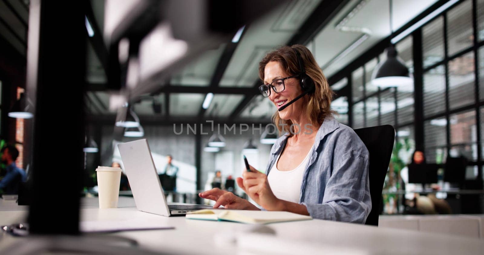 Smiling Call Center Representative Offers Exceptional Customer Care Via Phone.