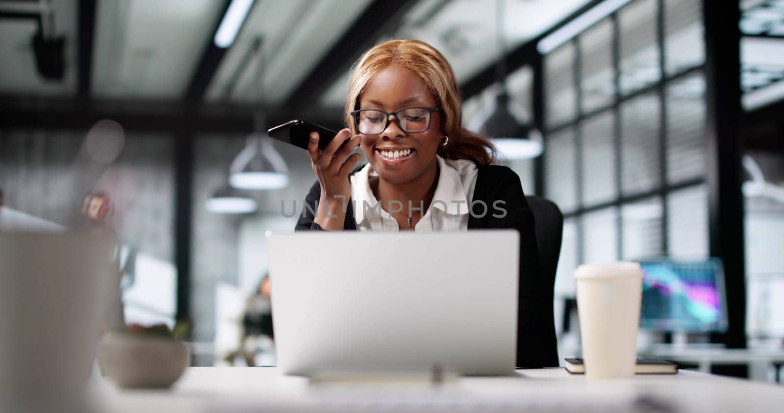 Smiling African Coach Speaks With Client On Smartphone, Happy Interaction.