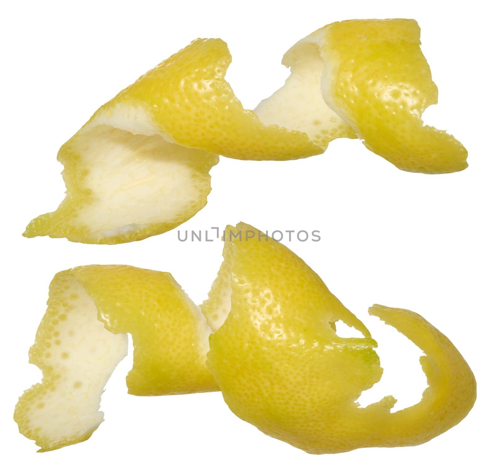 Two twisted strips of lemon peel showing the bright yellow outside and white inside. Close-up of the peel on an isolated background.