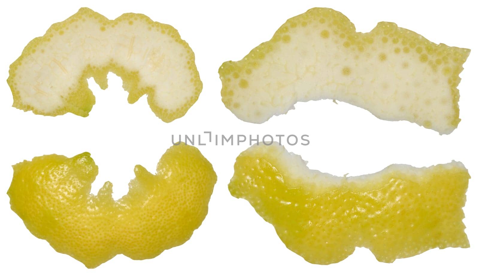 Four pieces of lemon peel in different shapes showing the white inside and yellow outside. Isolated background