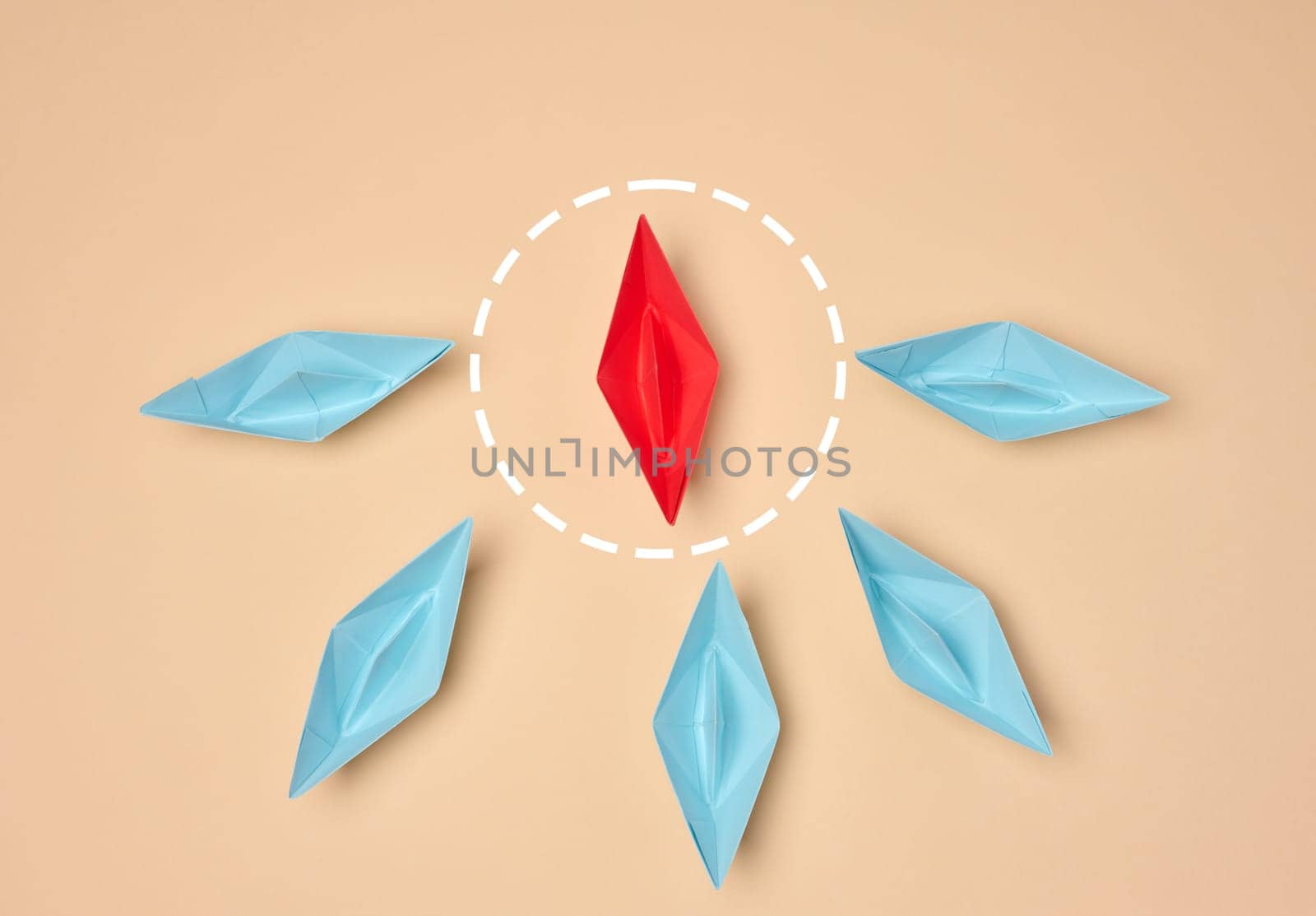 Leadership and individuality concept. One red origami boat surrounded by six blue boats on a beige background. The red boat is highlighted with a dotted circle
