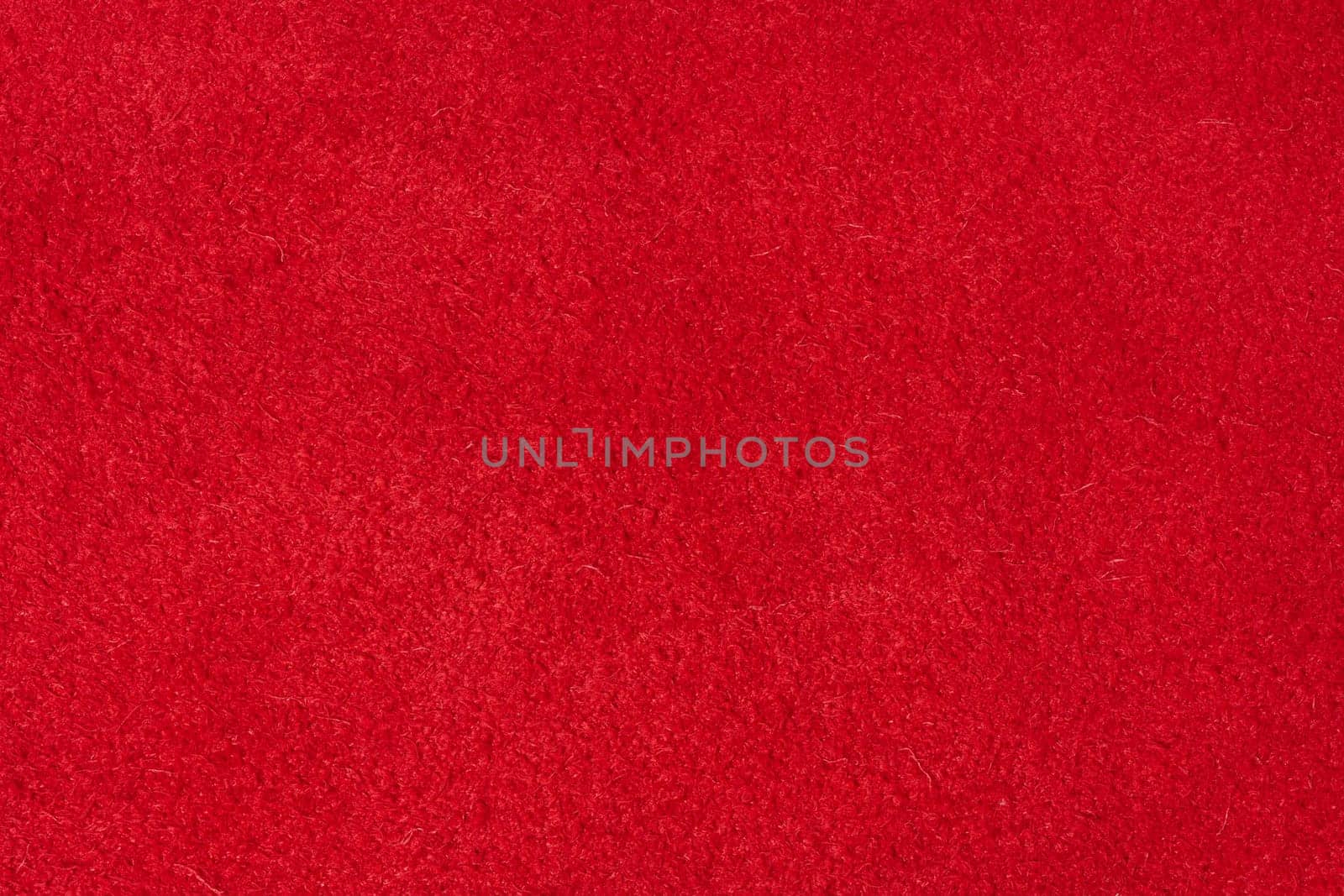 Close up of rich red suede showing the soft, shaggy surface texture with visible fibers