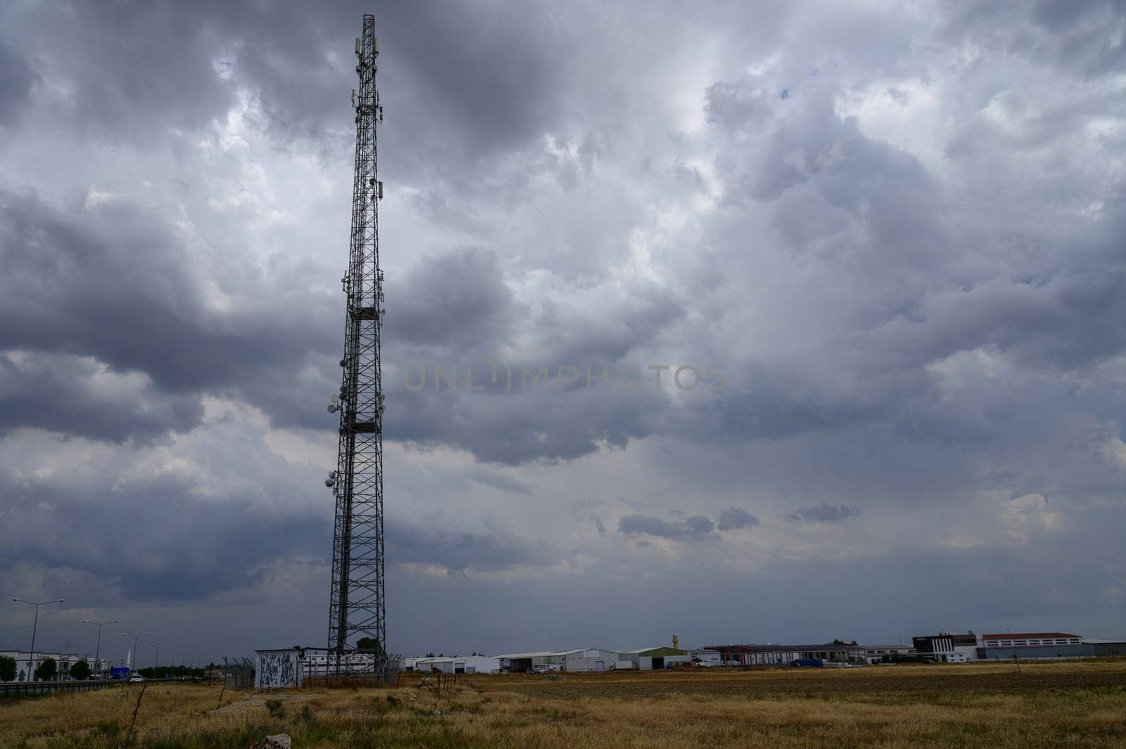 Telecommunication tower for mobile network coverage standing on a hill in Cyprus against a clear sky, ensuring signal strength in rural and urban areas.