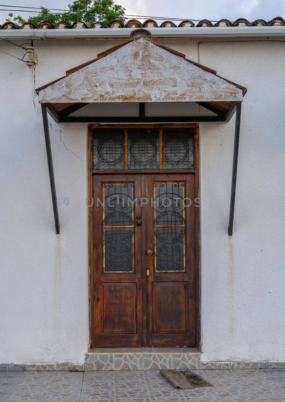 Vintage wooden door with rustic texture in a traditional Cypriot stone house, showcasing Mediterranean architecture and charm.