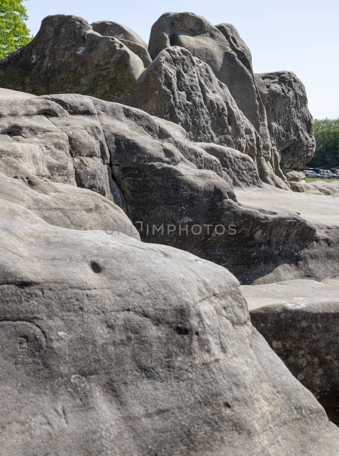 The stunning view of An unusual outcrop of natural sandstone rocks on Wellington Rocks at Tunbridge Wells Common. use it as your Wallpaper, Poster and Space for text, Selective focus.