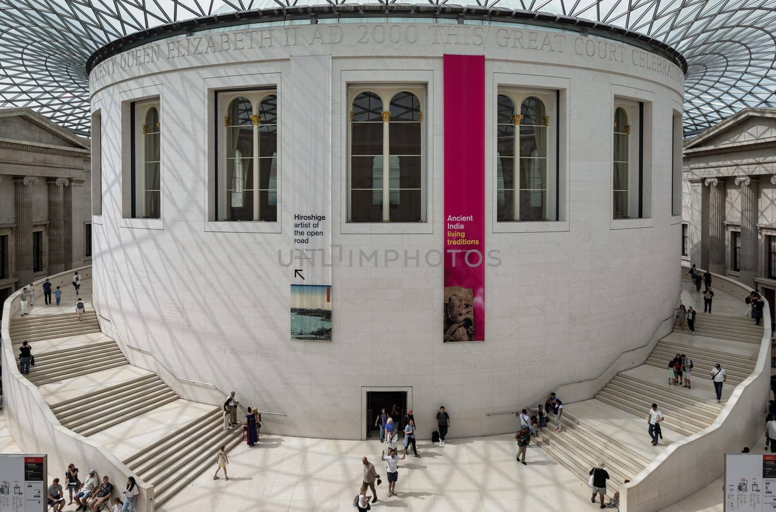 London, UK - May 31, 2025 - People and tourists visitors inside The Queen Elizabeth II Great Court or the Great Court has a gridshell roof covered with panels of glass over the entire courtyard situated in the centre of the Great Court of the British Museum. use it as your Wallpaper, Poster and Space for text, Selective focus.