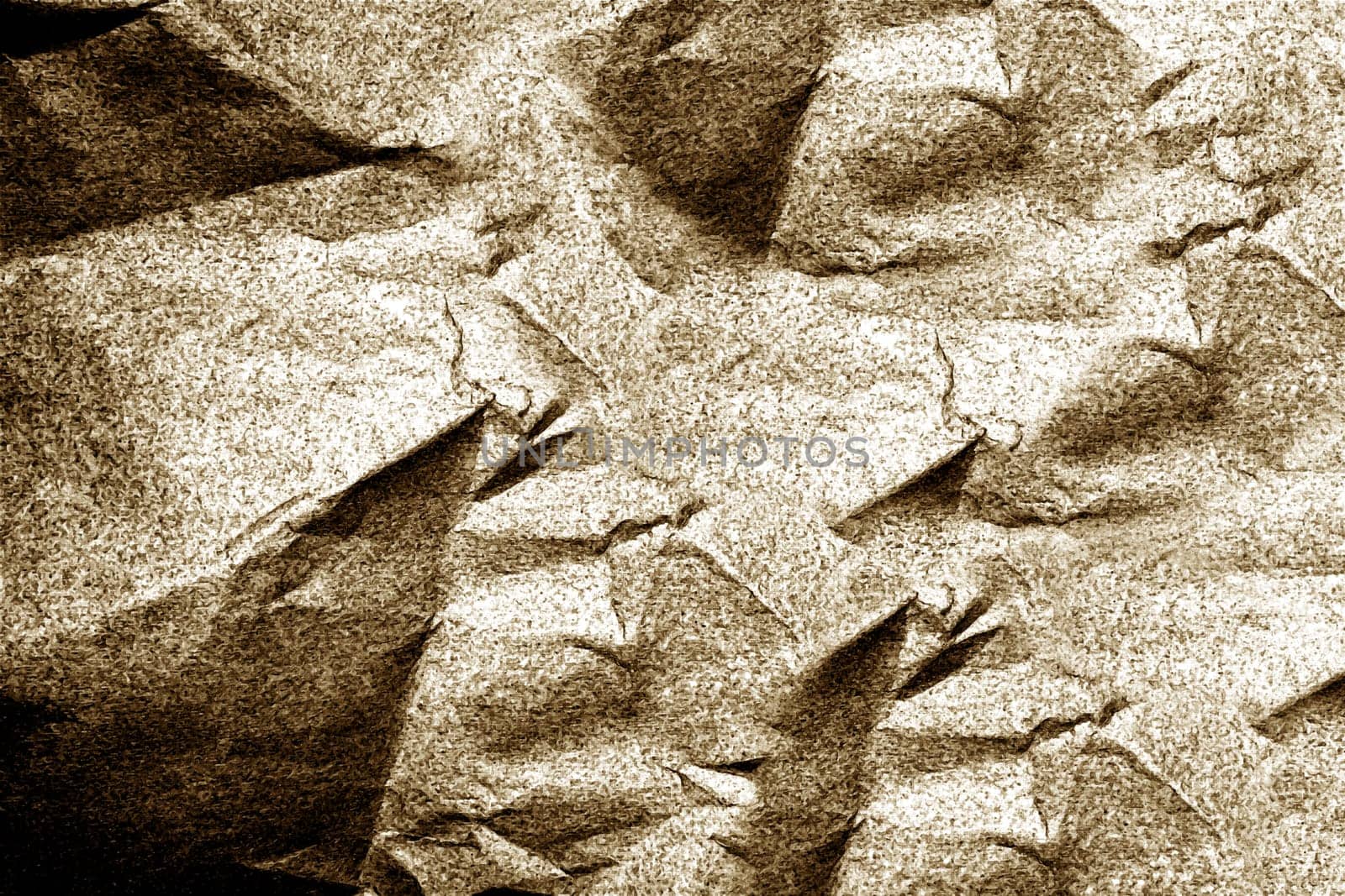 Crumpled paper forms an abstract textured background, illuminated with soft light brown hues