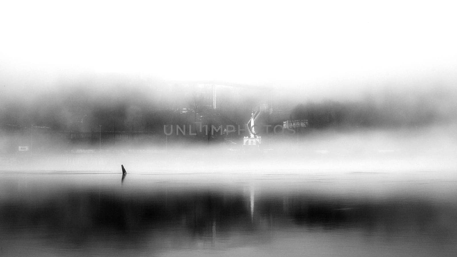 The thick fog lends an air of mystery to the scene, softening the edges of the landscape and blurring the boundaries between reality and imagination.