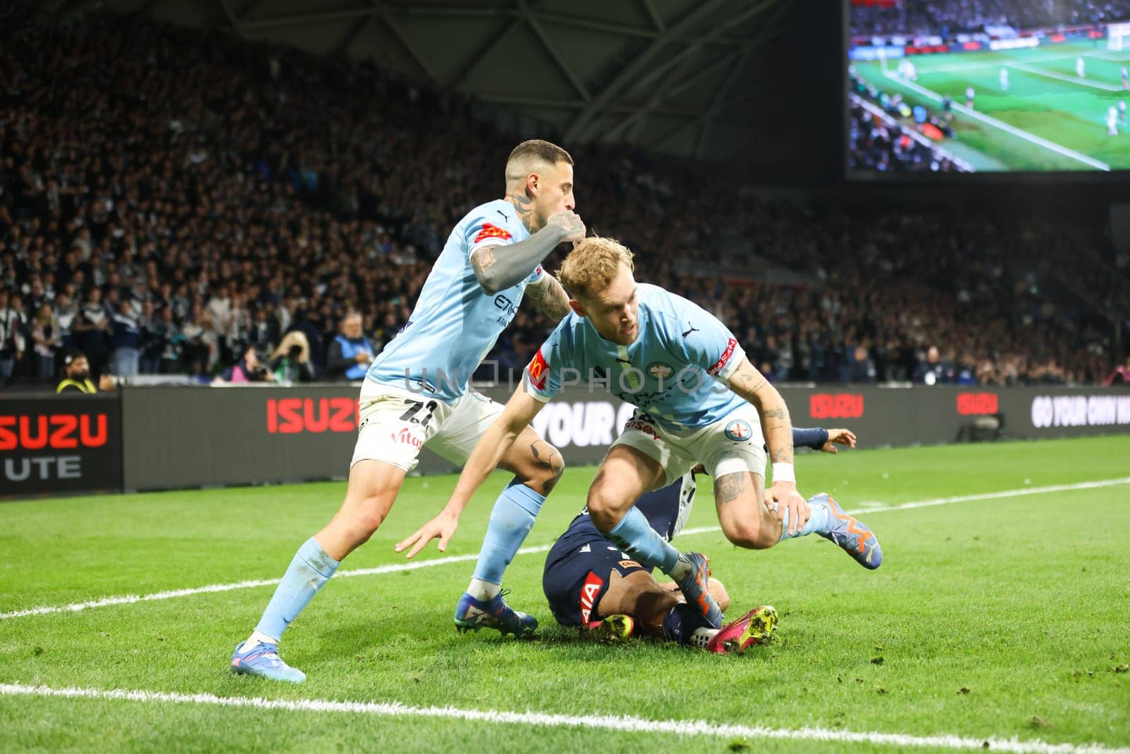MELBOURNE, AUSTRALIA - MAY 31: German Ferreyra and Nathaniel Atkinson of Melbourne City battle with Daniel Arzani of Melbourne Victory during the A-League Men Grand Final match between Melbourne City and Melbourne Victory at AAMI Park on May 31, 2025, in Melbourne, Australia.