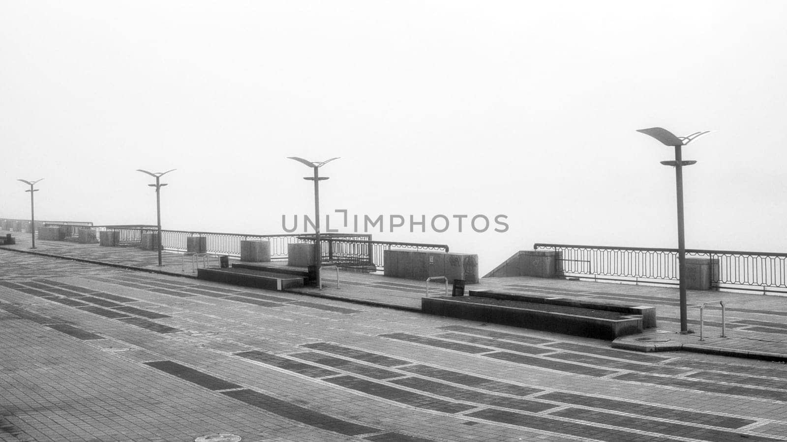The dense mist obscures the details of the landscape, veiling the quayside in an enigmatic shroud. High quality photo