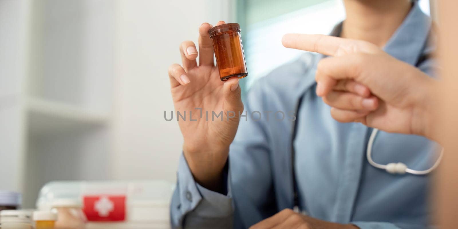 A doctor shows a prescription bottle to a patient, emphasizing communication and understanding in medication management.