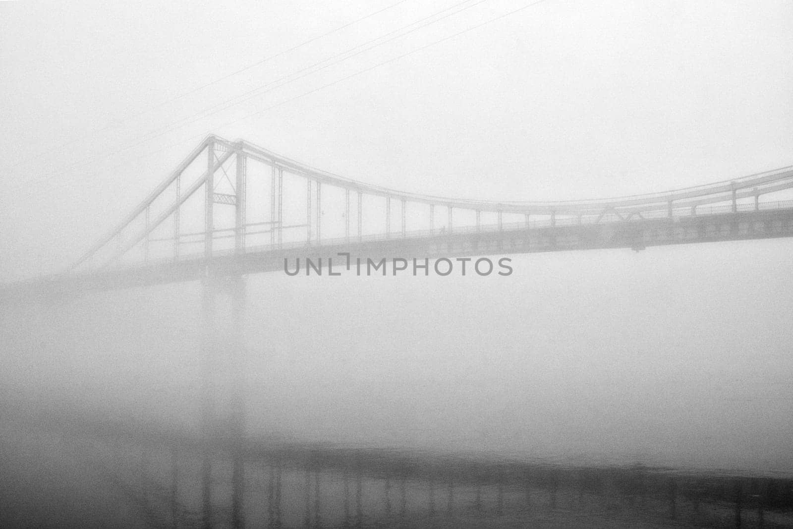 The thick fog lends an air of mystery to the scene, softening the edges of the landscape and blurring the boundaries between reality and imagination.