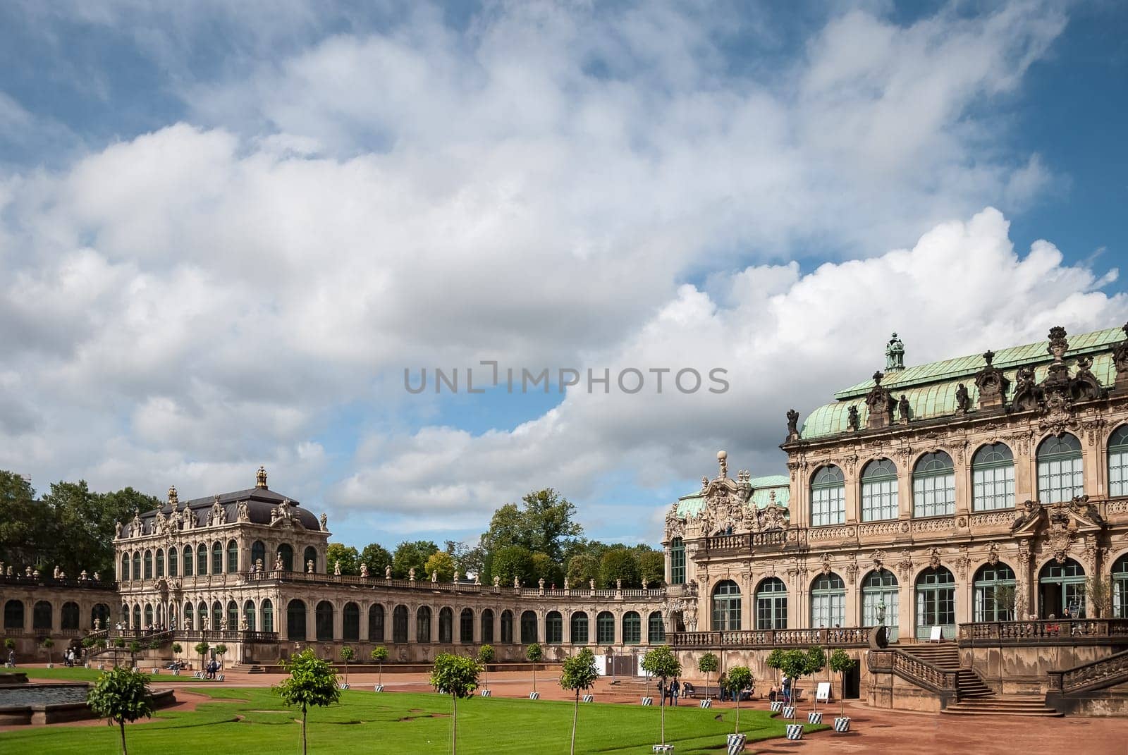 View of Zwinger square from steps of Old Masters Picture Gallery towards French and Rampant pavilions, Sep 10, 2017 - Dresden, Saxony, Germany. Great clouds in blue sky. Famous picture gallery with world-scale masterpieces, heavily ruined in WWII