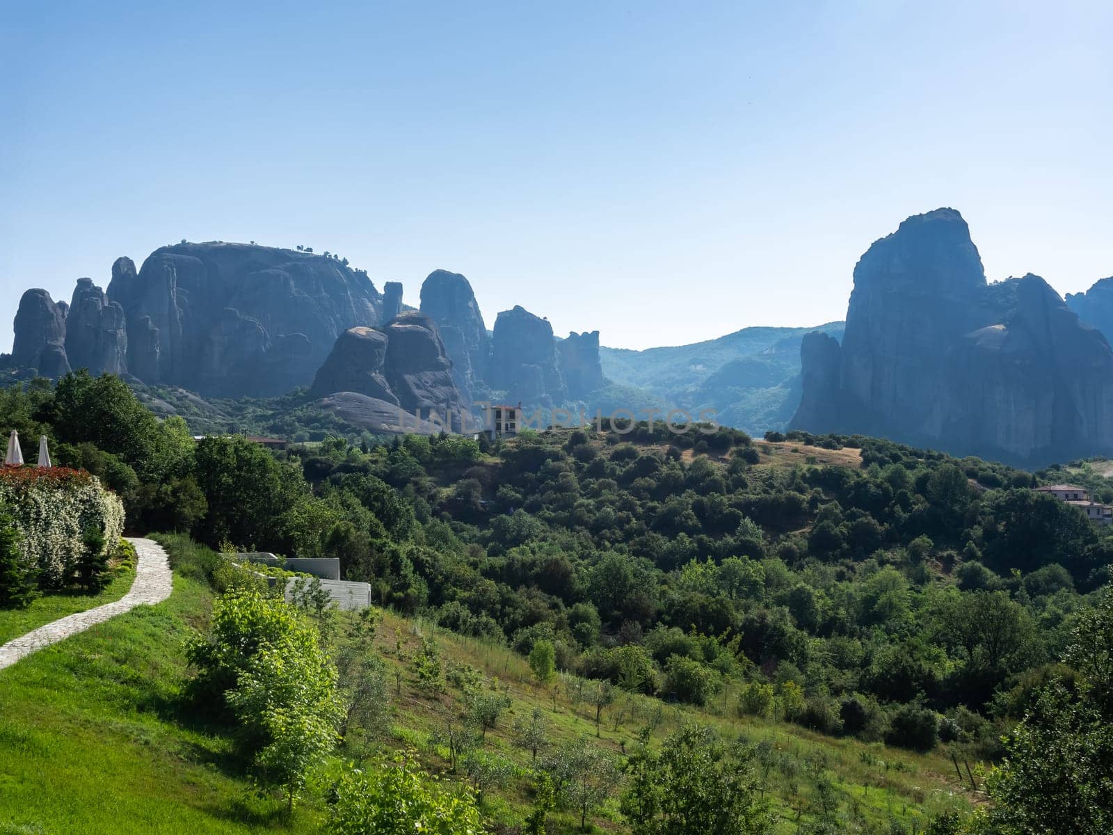 Panoramic view of Meteora rocks on a clear summer day/ Tourist destination, famous natural phenomenon of boulder rocks and religious attraction of Eastern Orthodox monasteries and nunneries atop of rocks.