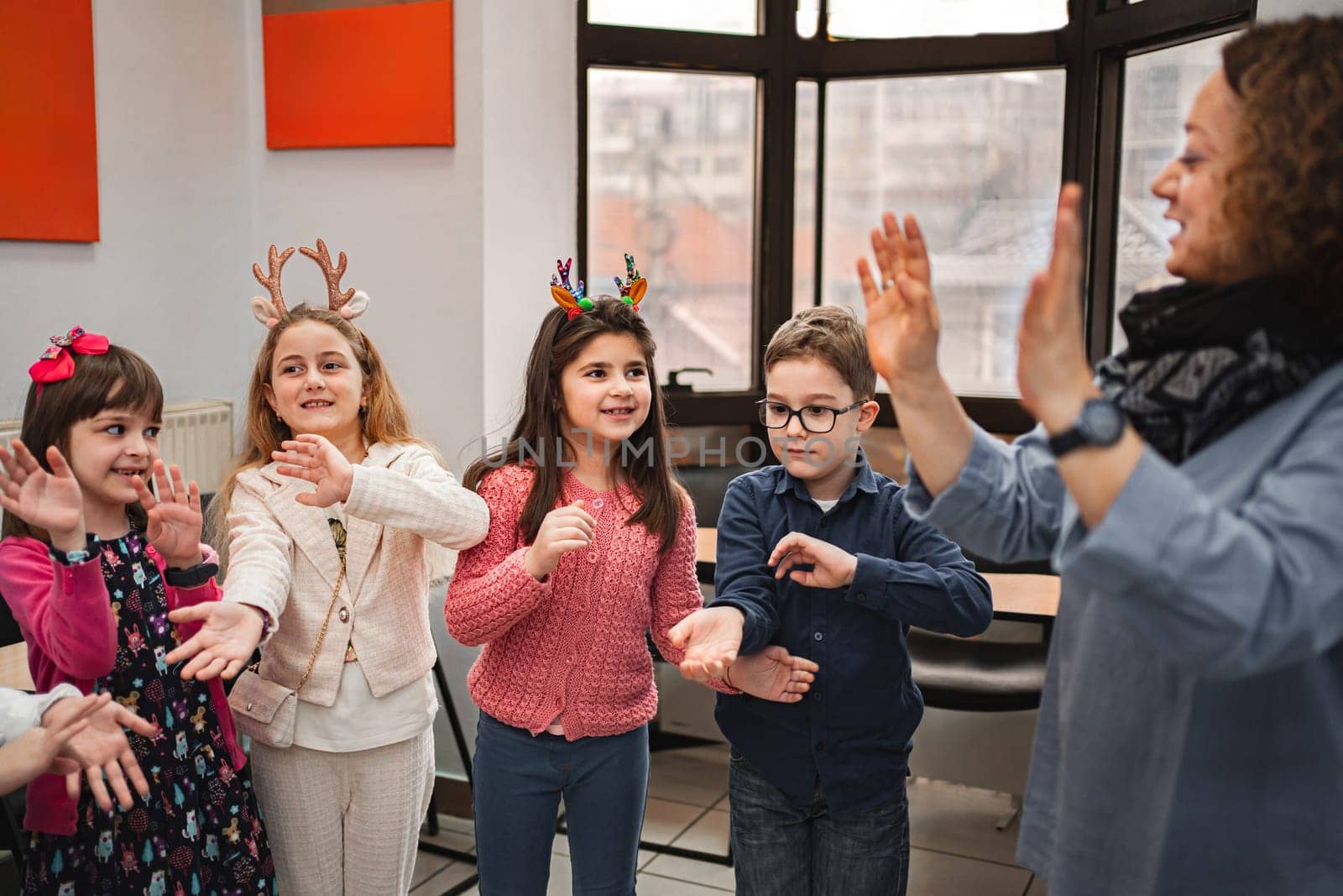 Teacher and elementary students at language school class.