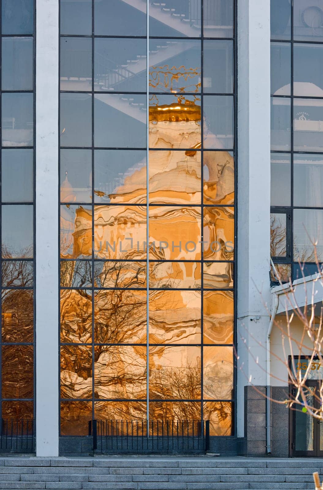 reflection of the Prince Vladimir Cathedral on the glass facade of the building in springtime. High quality photo