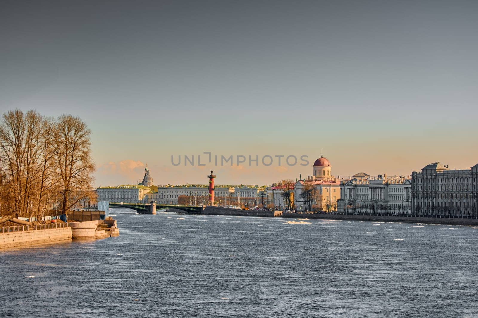 ice drift on the Neva River with a view of the arrow of Vasilyevsky Island with rostral columns, the Winter Palace, St. Isaac's Cathedral, the Savior on Spilled Blood. High quality photo