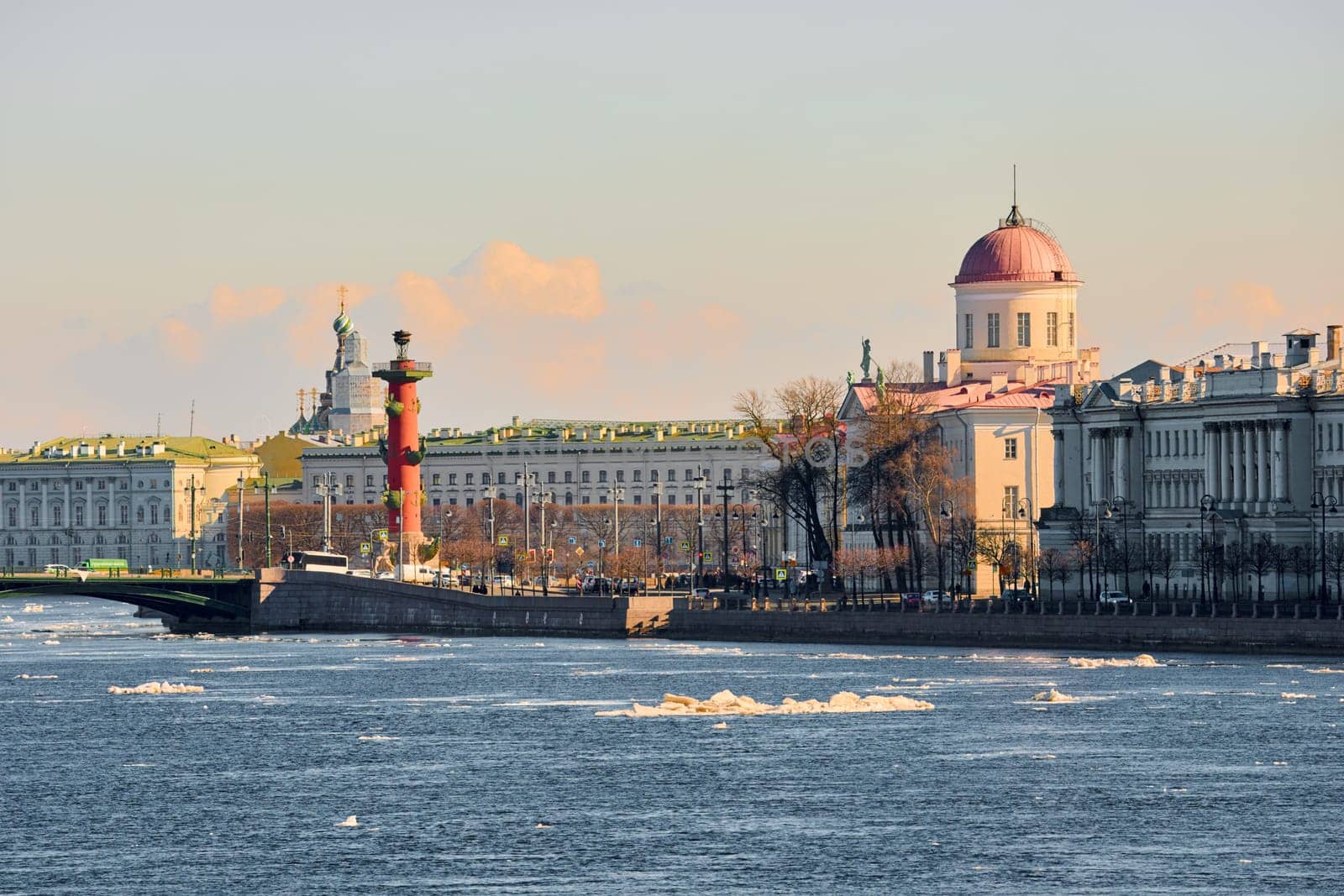 ice drift on the Neva River with a view of the arrow of Vasilyevsky Island with rostral columns, the Winter Palace, St. Isaac's Cathedral, the Savior on Spilled Blood. High quality photo