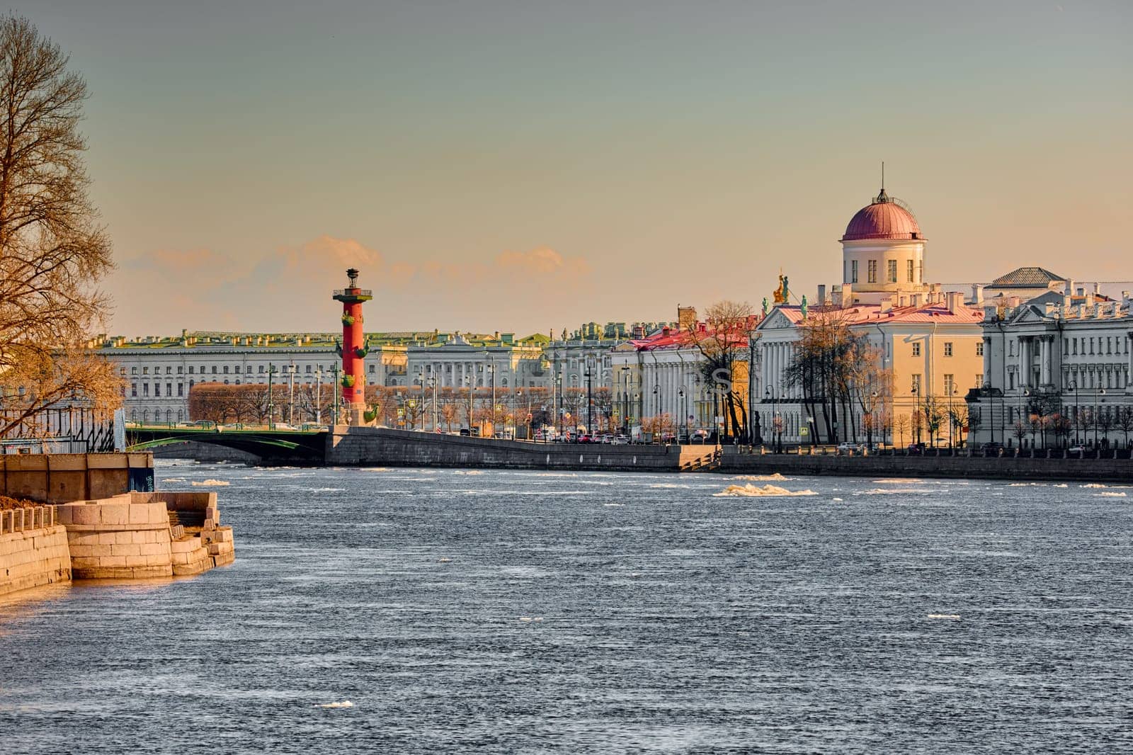 ice drift on the Neva River with a view of the arrow of Vasilyevsky Island with rostral columns, the Winter Palace, St. Isaac's Cathedral, the Savior on Spilled Blood. High quality photo