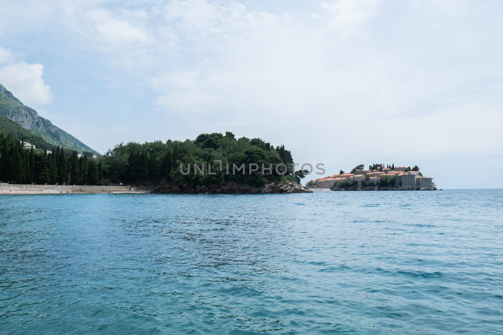 Sveti Stefan private island in Montenegro near Budva. Adriatic Sea Coast travel destination vacation holiday idea. Concept of getting away tourism experiences. Nature driven scenery wanderlust vibes