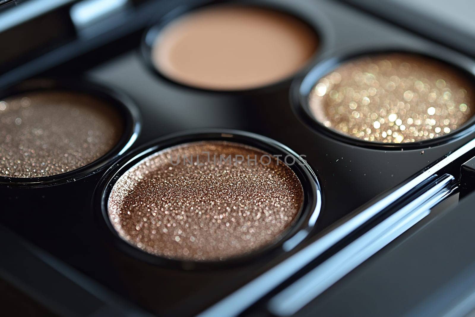 Natural brown eyeshadow shades in a black palette. Texture and color captured in high detail, emphasizing beauty.