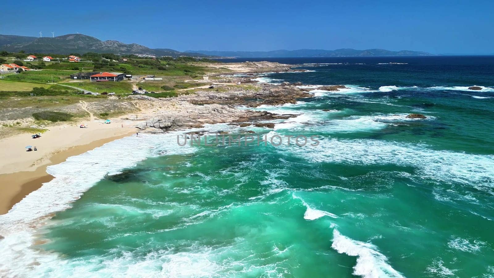 Enjoy stunning drone views of the coastline, with vibrant turquoise waves and majestic rocky landscapes